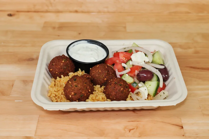 Crispy falafel over rice with salad and tzatziki.