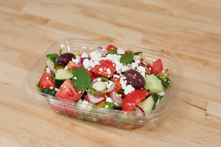 Greek salad with tomatoes, cucumbers, olives, onions and feta.