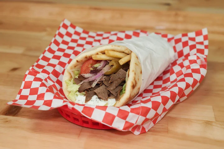Original beef gyro in warm pita with vegetables and fries.
