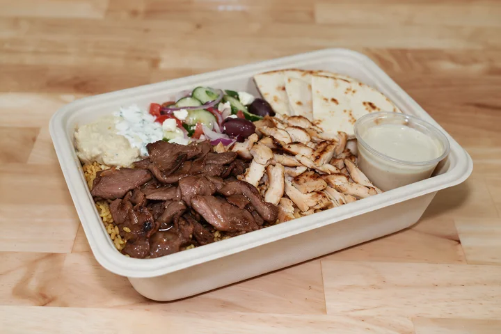 The Big Box with double meat over rice, salad, dips and pita.