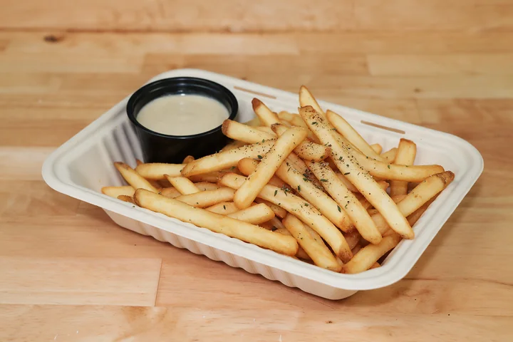 Golden zaatar-seasoned fries with a cup of tahini.